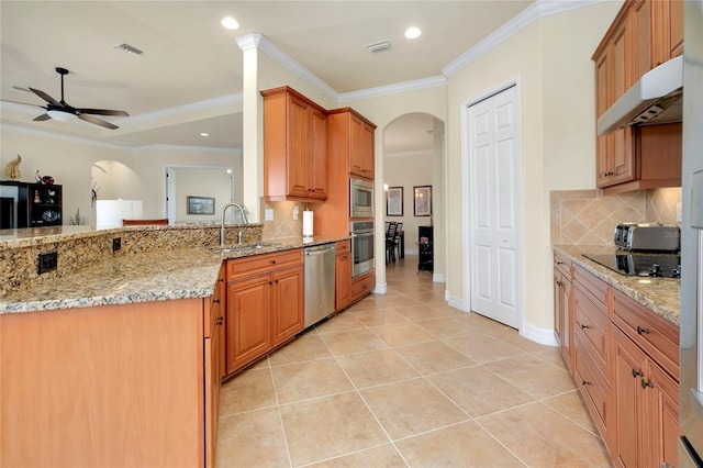 kitchen featuring decorative backsplash, light stone counters, stainless steel appliances, sink, and light tile patterned floors