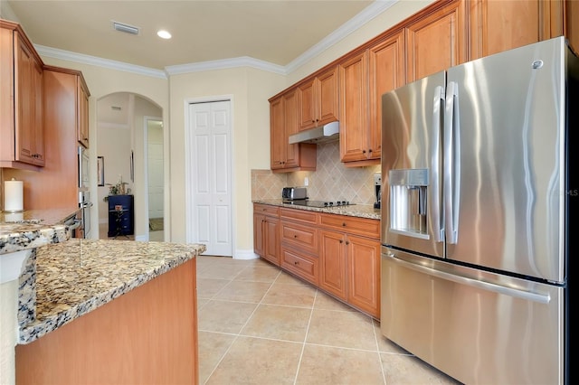 kitchen with light stone counters, crown molding, and appliances with stainless steel finishes