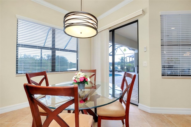 dining room with light tile patterned floors, a wealth of natural light, and ornamental molding