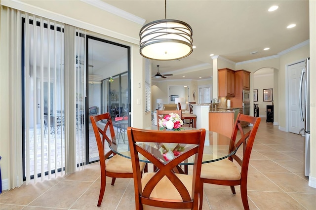 dining room featuring ceiling fan, light tile patterned flooring, and crown molding