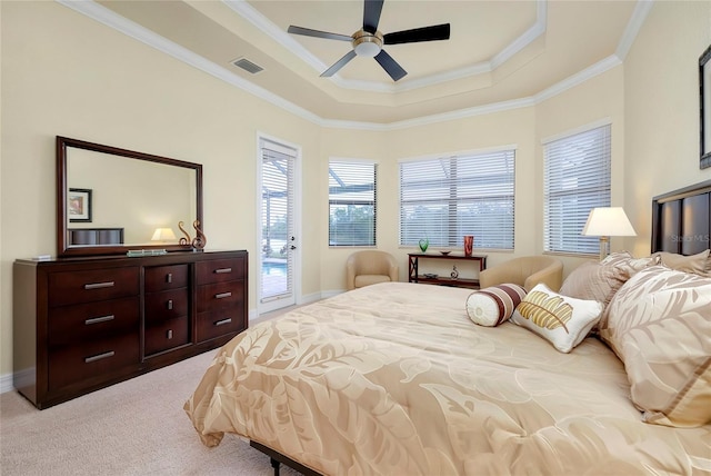 bedroom featuring access to exterior, light carpet, ornamental molding, a tray ceiling, and ceiling fan