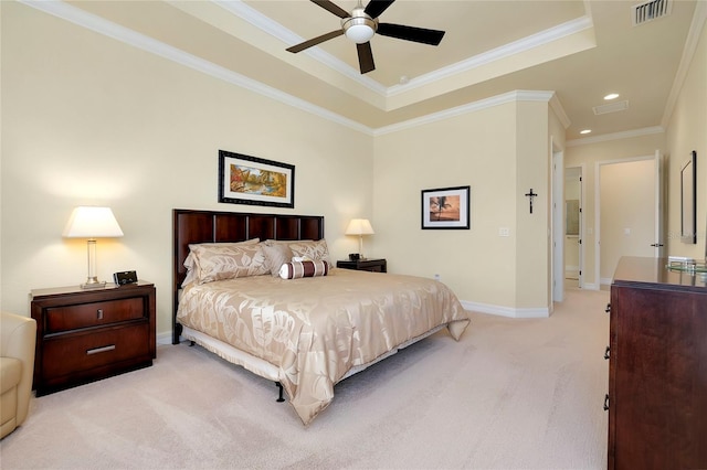 carpeted bedroom featuring a tray ceiling, ceiling fan, and crown molding