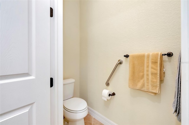 bathroom featuring tile patterned floors and toilet