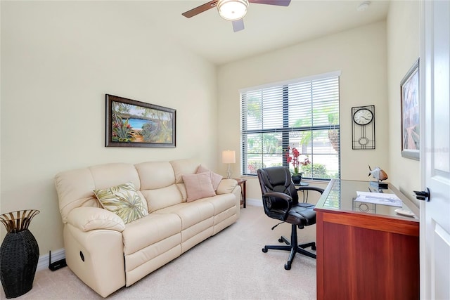 office area featuring light carpet and ceiling fan