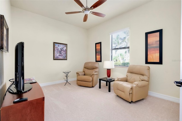 living area featuring ceiling fan and carpet floors