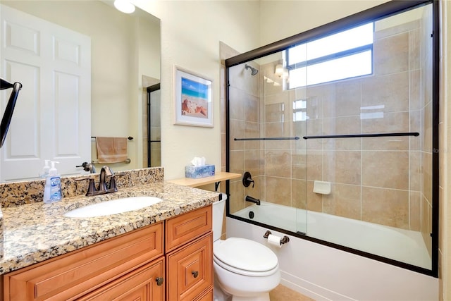 full bathroom with vanity, toilet, and shower / bath combination with glass door