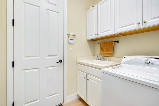 laundry area with cabinets, washer / dryer, light tile patterned floors, and sink