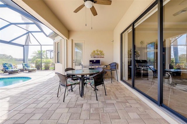 sunroom featuring ceiling fan and a pool