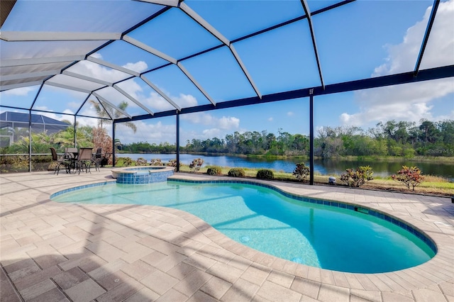 view of pool with an in ground hot tub, a water view, glass enclosure, and a patio area