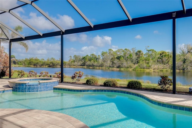 view of pool with an in ground hot tub, a patio, a water view, and glass enclosure