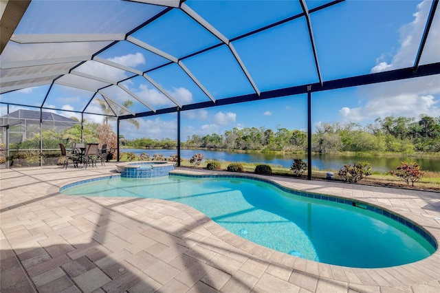 view of pool with an in ground hot tub, a lanai, a patio, and a water view