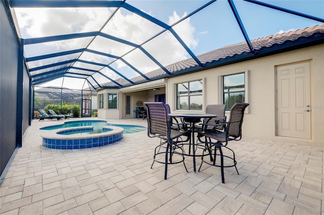 view of pool with a lanai, an in ground hot tub, and a patio