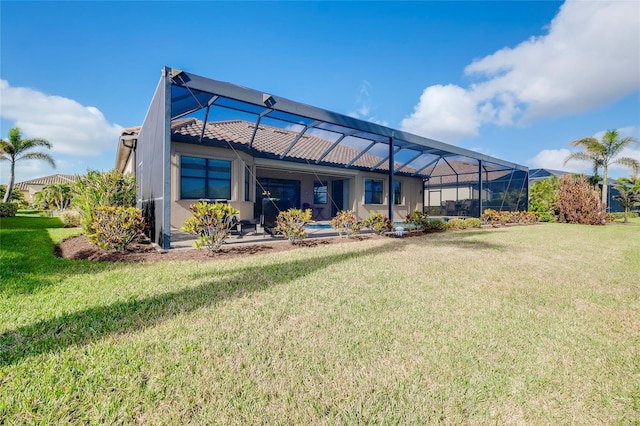 back of property with a yard and a lanai