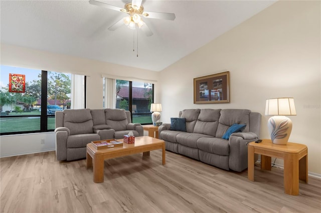 living room featuring ceiling fan, lofted ceiling, and light hardwood / wood-style flooring