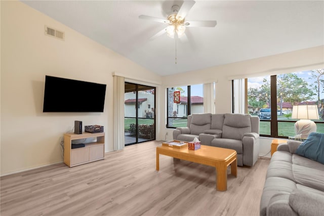 living room with ceiling fan, lofted ceiling, and light wood-type flooring