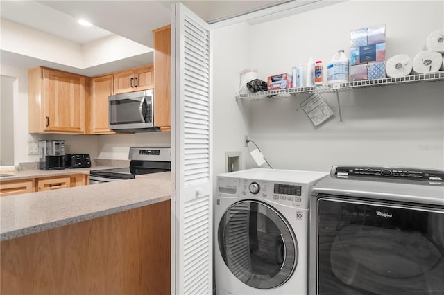 clothes washing area featuring washing machine and dryer