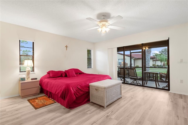 bedroom featuring access to exterior, light wood-type flooring, multiple windows, and ceiling fan