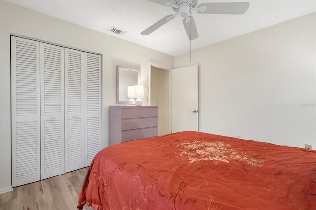 bedroom featuring ceiling fan, a closet, and light hardwood / wood-style flooring