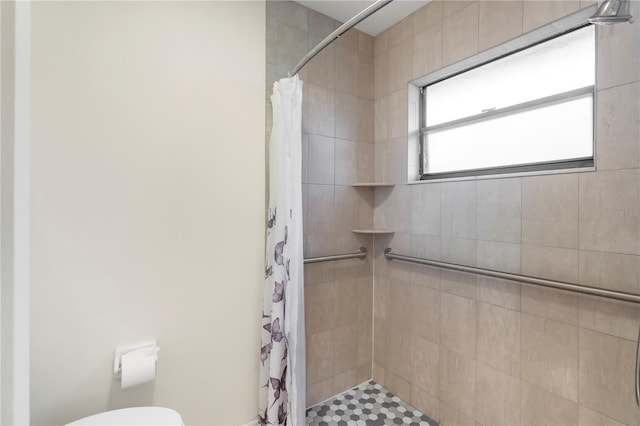 bathroom with toilet and walk in shower