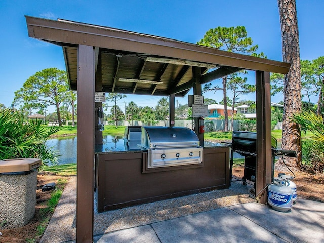 view of patio featuring a gazebo, area for grilling, a water view, and grilling area