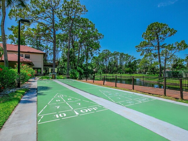 view of property's community featuring a water view and tennis court