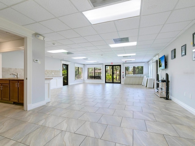 interior space with a paneled ceiling and sink