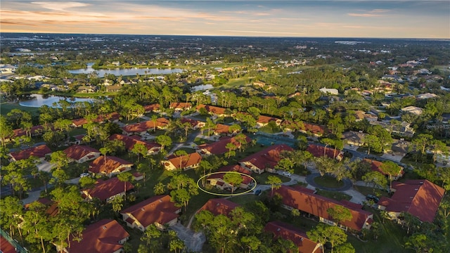 aerial view at dusk with a water view