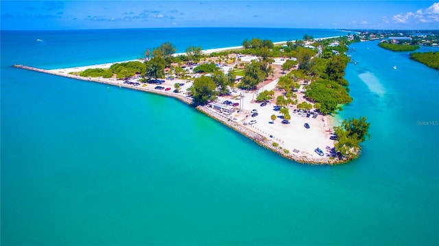 birds eye view of property with a water view and a beach view