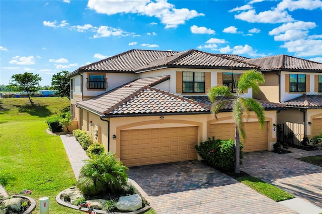 mediterranean / spanish-style house with a garage and a front yard