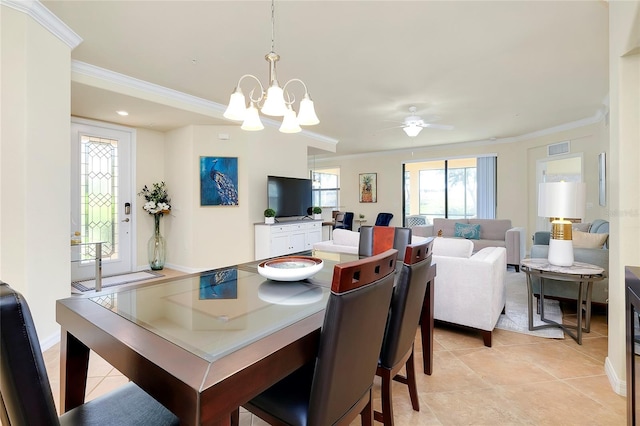 tiled dining space with crown molding and ceiling fan with notable chandelier