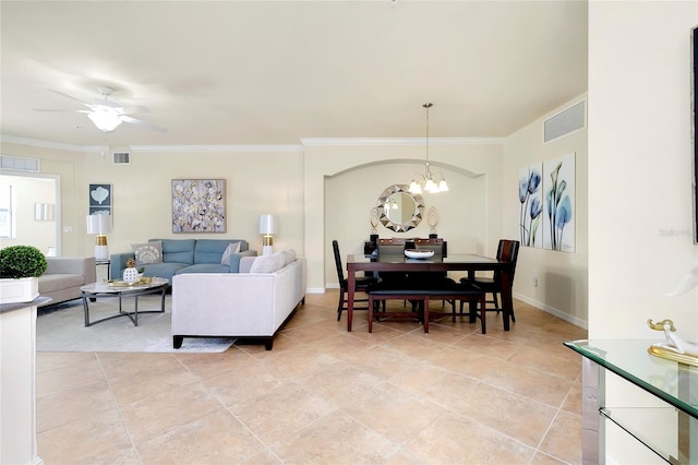 living room with ceiling fan with notable chandelier and ornamental molding