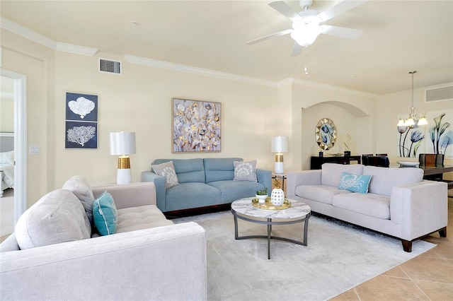 living room featuring ceiling fan with notable chandelier, light tile patterned flooring, and ornamental molding