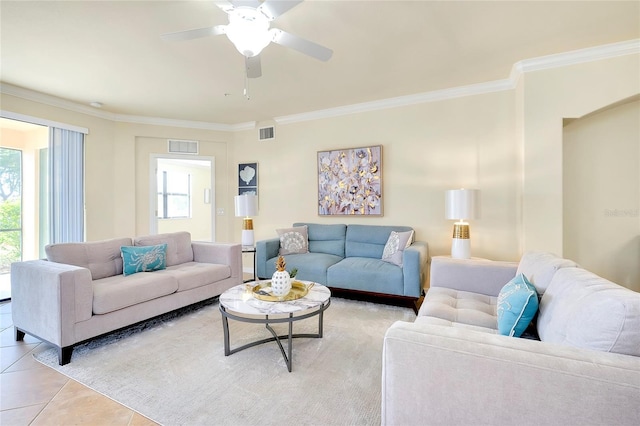 tiled living room featuring crown molding, ceiling fan, and a healthy amount of sunlight