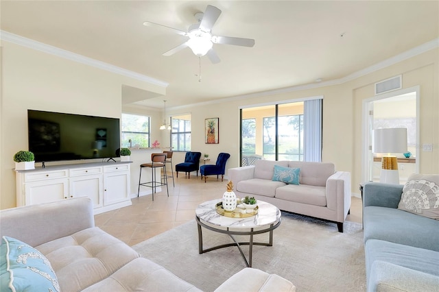 tiled living room featuring ceiling fan with notable chandelier and crown molding