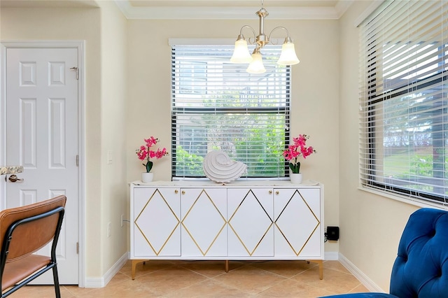 sitting room with light tile patterned floors, ornamental molding, a wealth of natural light, and a chandelier