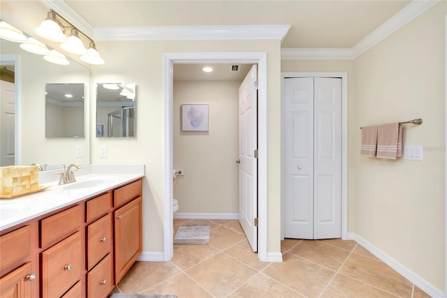 bathroom with tile patterned floors, vanity, toilet, and ornamental molding