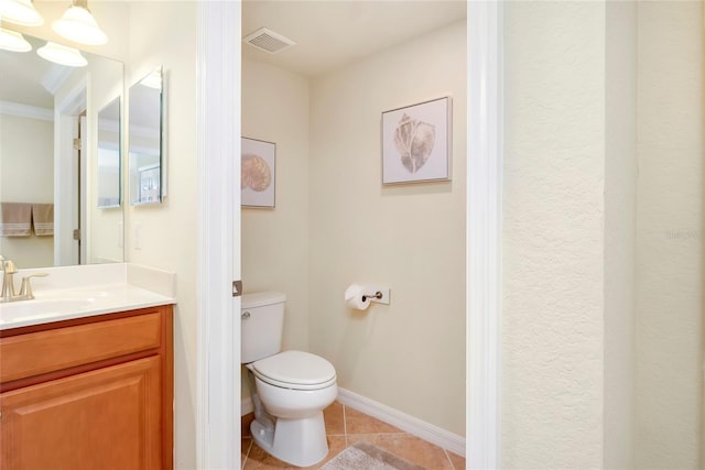 bathroom featuring tile patterned floors, vanity, toilet, and crown molding