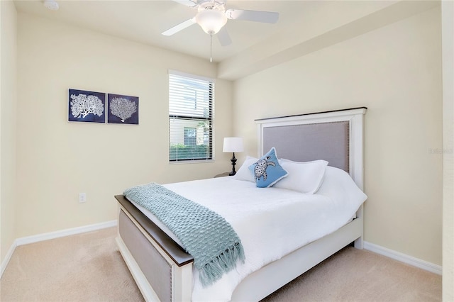 bedroom featuring light colored carpet and ceiling fan