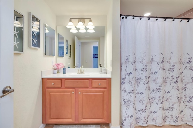 bathroom with vanity, walk in shower, and a chandelier