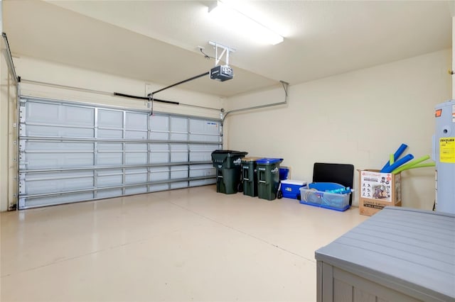 garage featuring electric water heater and a garage door opener