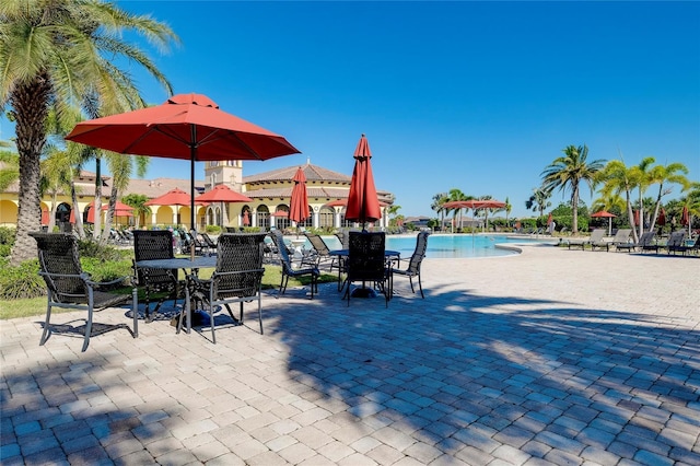 20100 Ragazza Cir Unit 101, Venice, FL 34293 - view of patio featuring a community pool and outdoor dining area