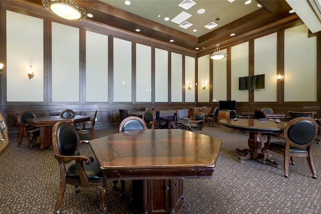 carpeted dining room featuring a tray ceiling