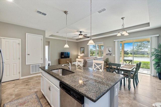 2049 Mesic Hammock Way, Venice, FL 34292 - kitchen with dishwasher, a tray ceiling, a ceiling fan, white cabinets, and dark stone countertops