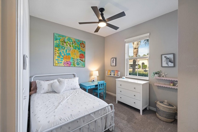 bedroom with ceiling fan and dark carpet