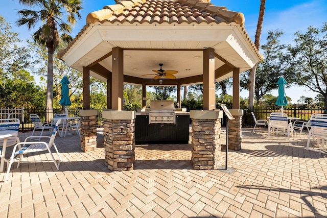 view of patio / terrace with grilling area, ceiling fan, an outdoor kitchen, and a gazebo