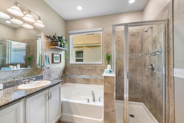 bathroom featuring vanity and plus walk in shower