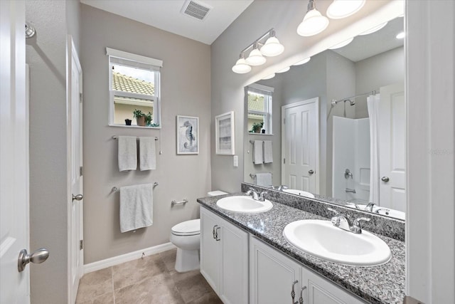 bathroom with toilet, a healthy amount of sunlight, and vanity