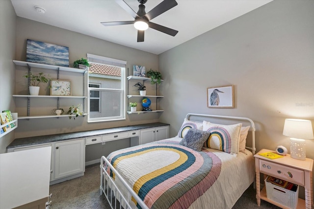 bedroom featuring ceiling fan and dark carpet