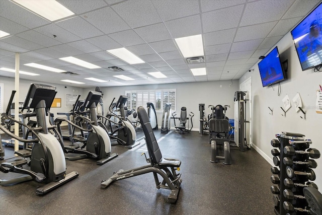 gym with a paneled ceiling