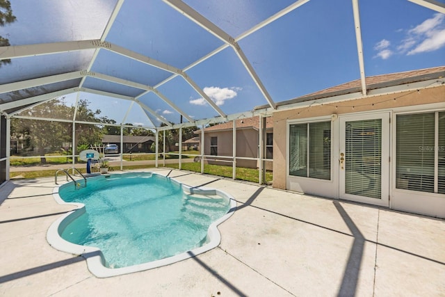 view of swimming pool with a lanai and a patio area